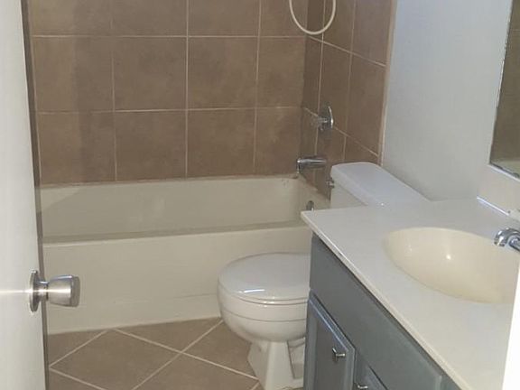 full bathroom upstairs in hallway between bedroom 2 and 3 with custom tile work and linen closet