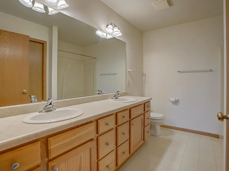 Full bathroom upstairs with double sinks