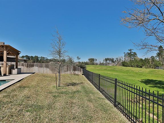Wrought iron fence overlooks greenbelt area but privacy fence between neightbors!