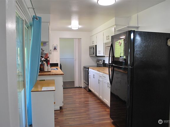 Galley Kitchen. Step out slider to patio, go straight for half bath & W/D.>