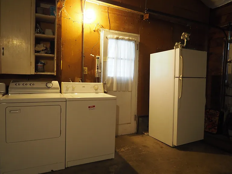 Garage with 2nd refrigerator, washer and dryer.