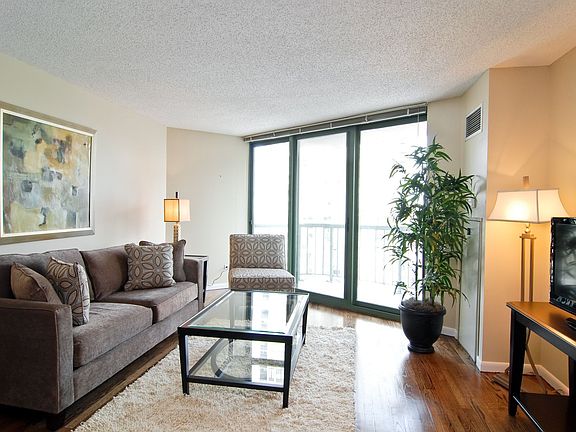 Living Room with Floor to Ceiling Windows leading to Private Deck
