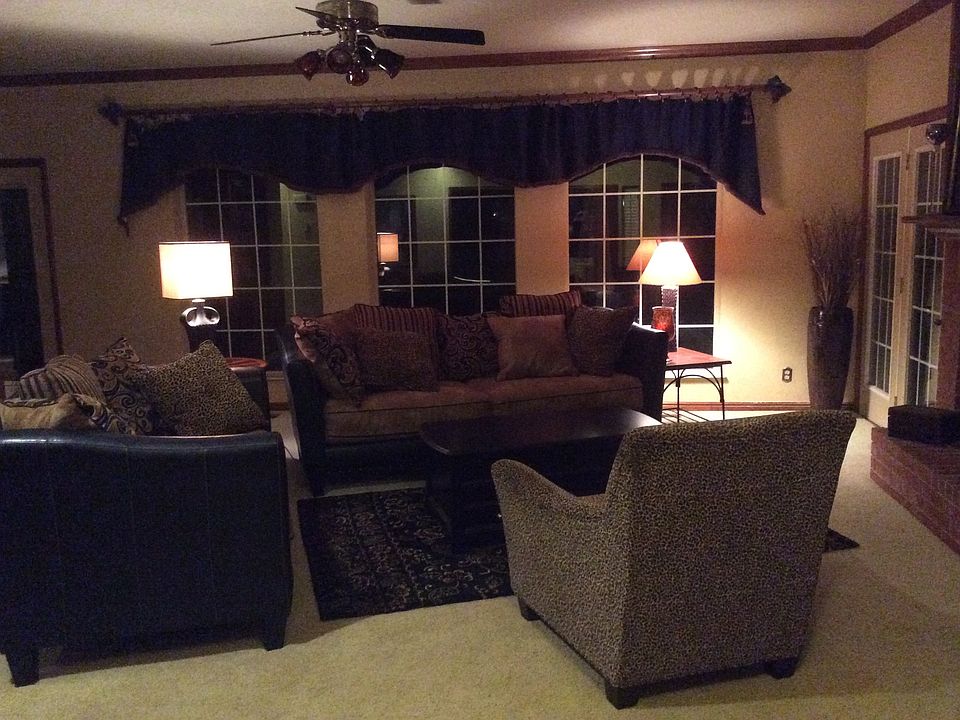 living room with beautiful view of mature trees out all back