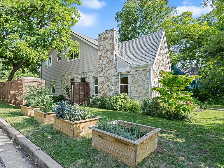 Exterior highlighting the original 1937 stone facade and the modern addition.