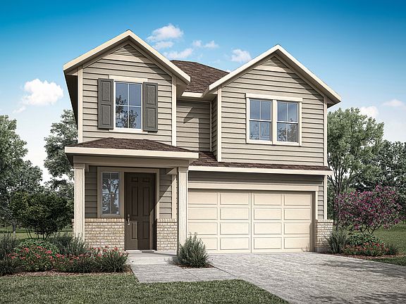 A two-story residential house with a garage, surrounded by lush greenery and a clear blue sky.
