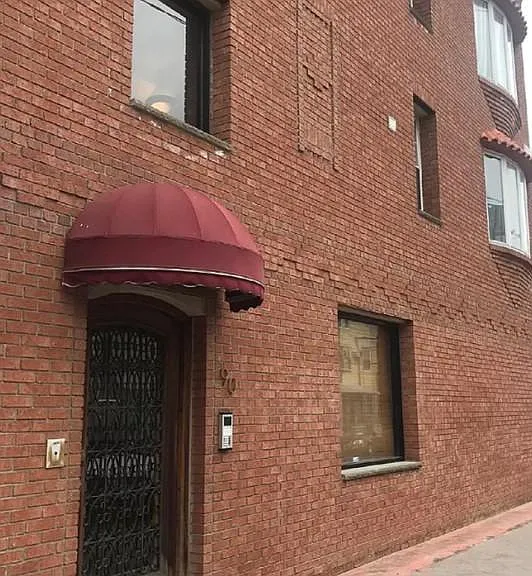 Fantastic brick building with an ornamental front door with intercom system. Great paver sidewalk around the building.