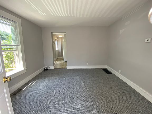 Living room facing towards kitchen.