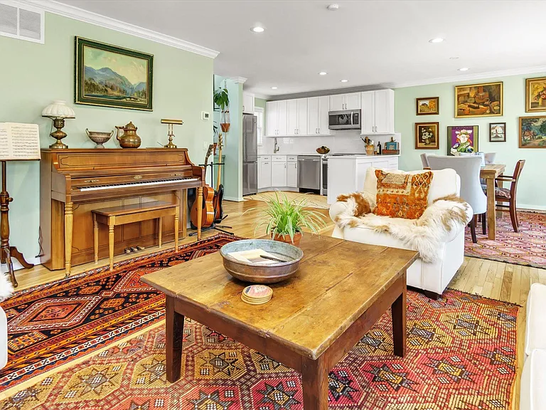 Beautiful layout, living room with sliders to patio, 1/2 renovated bath, dining area, kitchen, and foyer