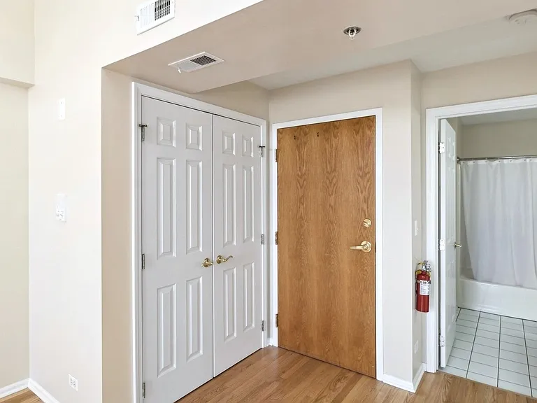 Entrance inside the residence. laundry unit to the left. Bathroom & bedroom to the right.