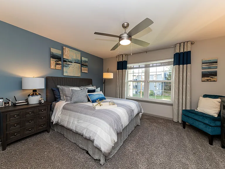 Cozy bedroom with carpet and ceiling fan