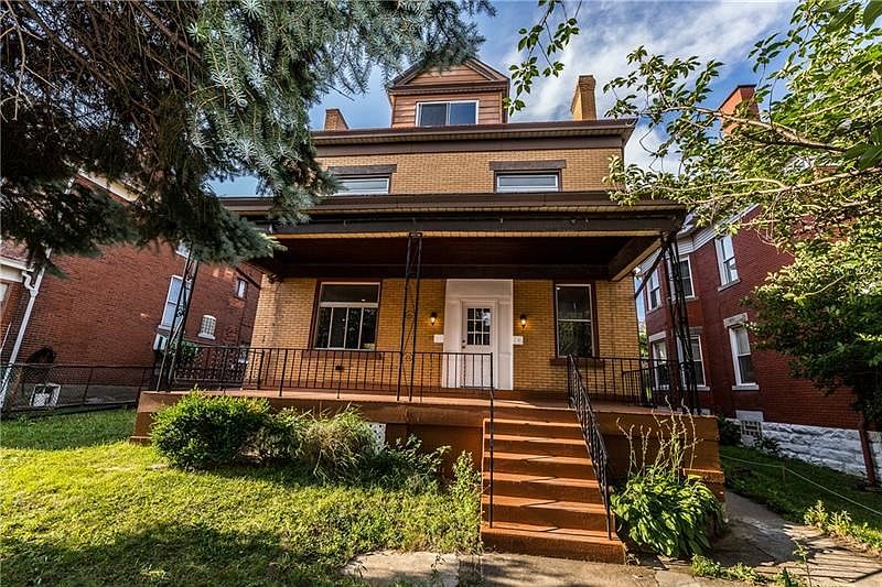 Beautiful 4-square architecture.   The front porch is relatively private, hidden behind evergreens and magnolias.  It's ready fo