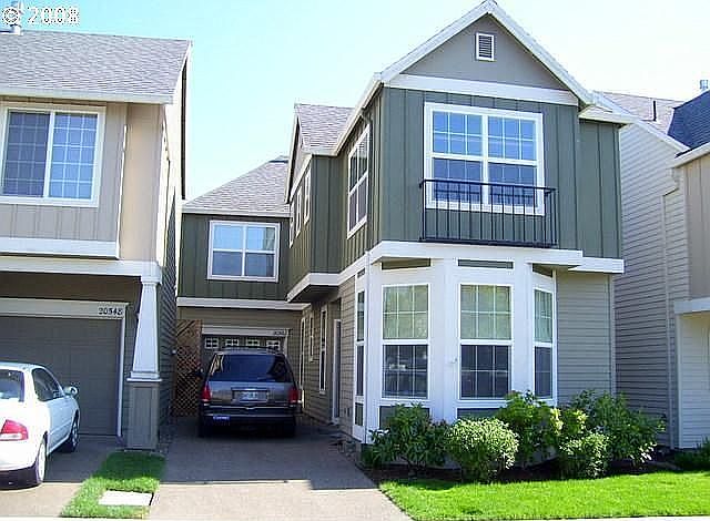 Front of house with tandem driveway
