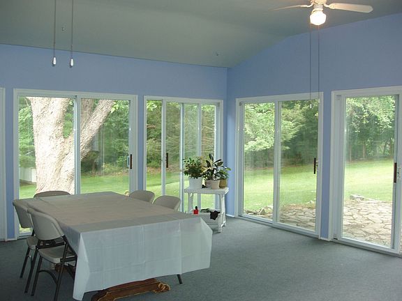 Florida room with 9 sliders to the private back yard