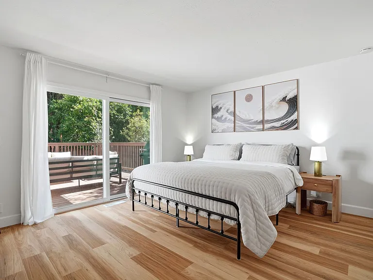 Downstairs Spacious bedroom, king with charging station nightstands and full dresser. TV and walk-in closet! Access to the backyard deck with views of the golf course.