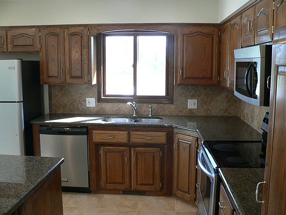 Large kitchen with granite counter tops, island and stainless steel appliances