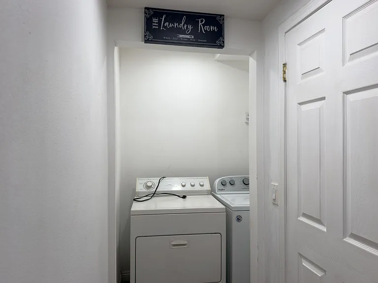 Dedicated laundry nook with side-by-side washer and dryer, offering convenient in-home laundry and easy access off the hallwa