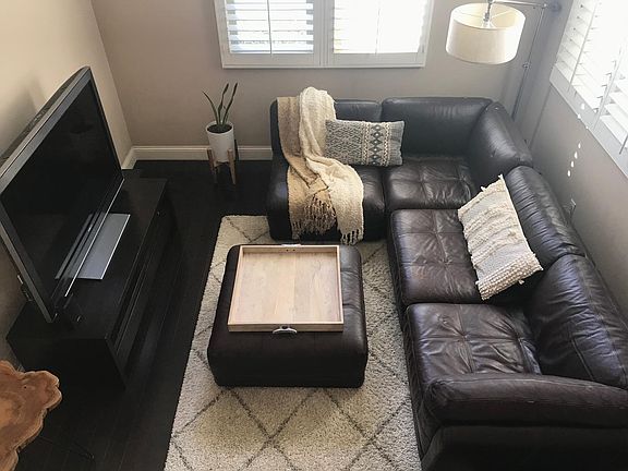 Living room w/ leather modular/sectional couch