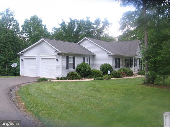 Two car garage with asphalt drive way