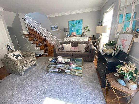 Large living rooms leads to wide hard-wood stairs and the second level