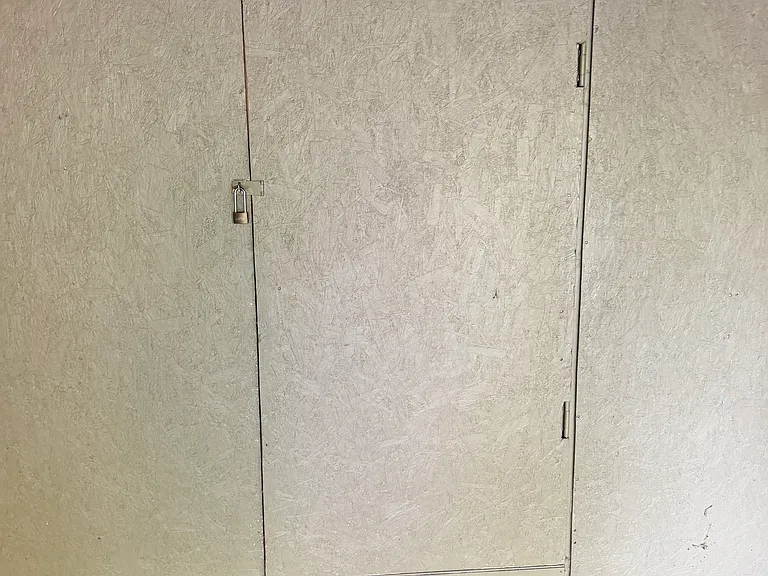 storage unit at back of carport parking spot