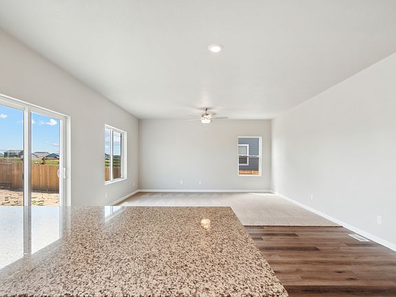 The dining room and family room of the Laramie sits right next to the kitchen.