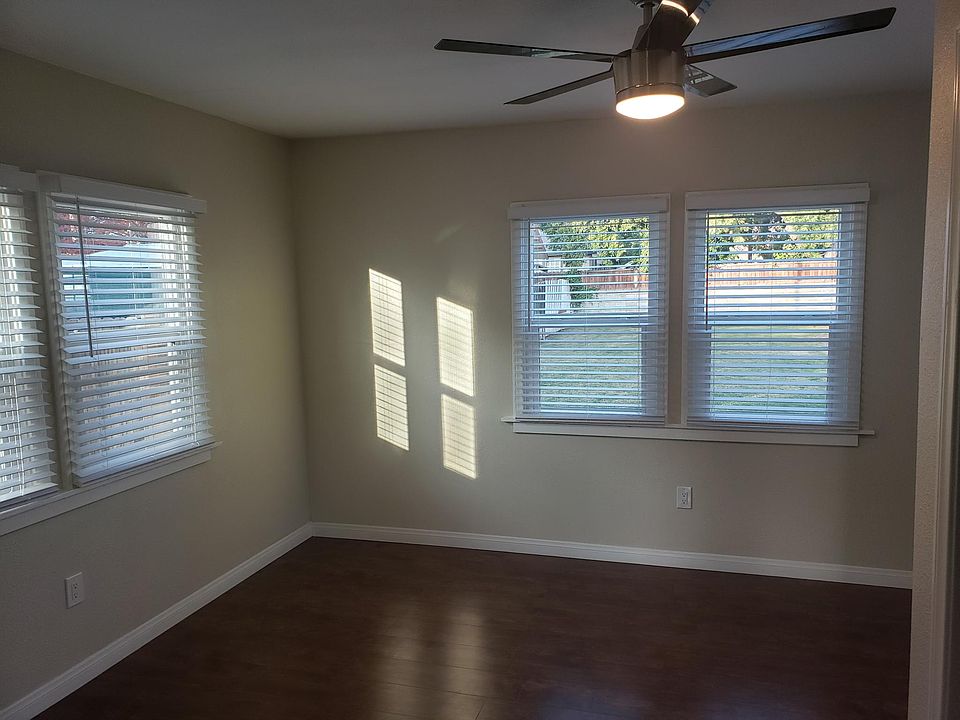 Bedroom with remote control lighting and ceiling fan.