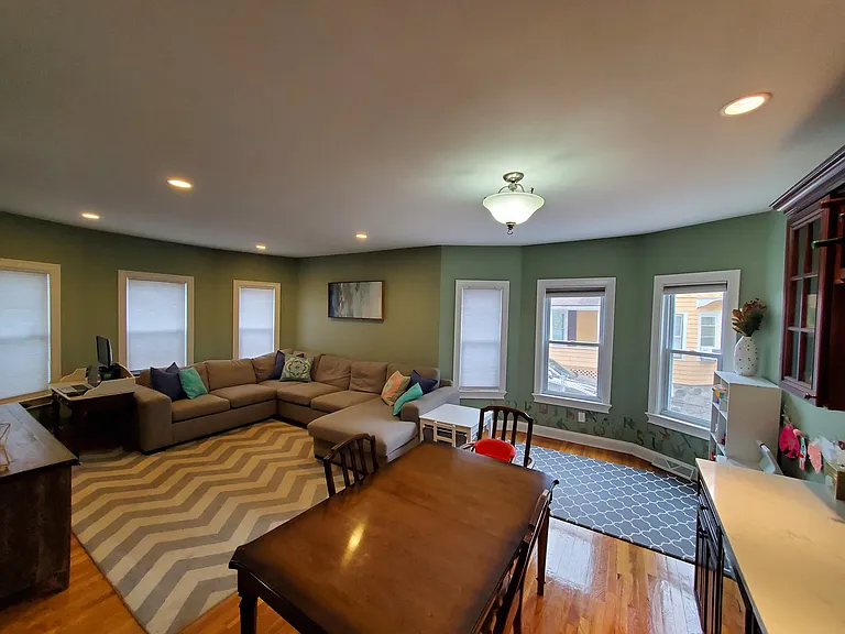 Living room and dining room area with wet bar and mini fridge