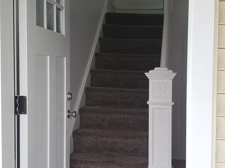 Front door and stairwell to second floor