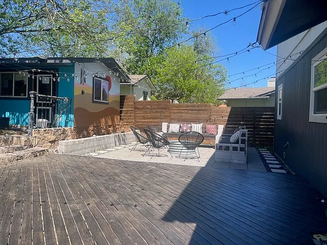 deck, string lights, firepit area with couches and chairs, and the "office"
