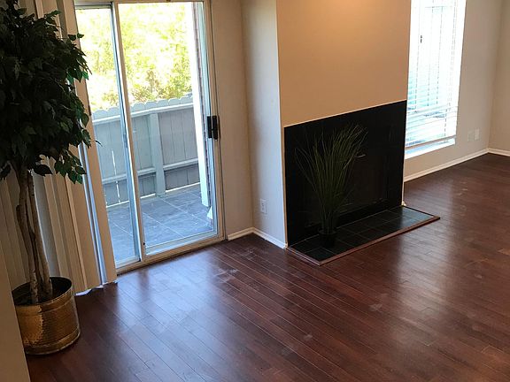 Living room with fireplace existing to patio