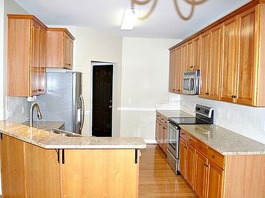 Large kitchen with gorgeous new granite counter tops and tile backsplash
