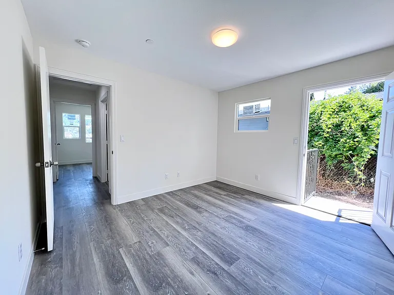 masterbedroom with door leading to sideyard