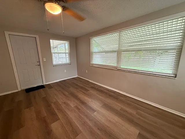 Master bedroom with addition of window treatments and full white door