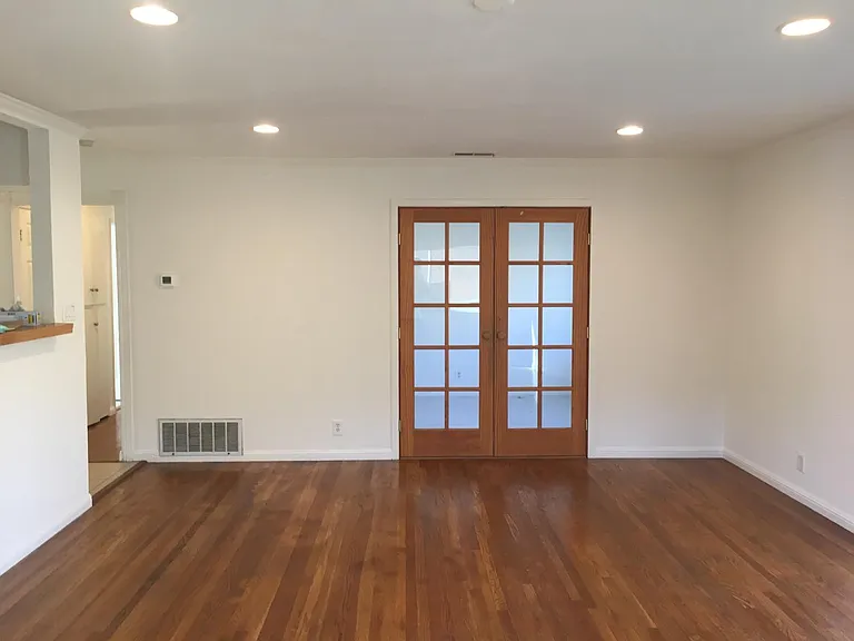 Another living room room, looking into Bedroom #4/office with a closed double french door for privacy
