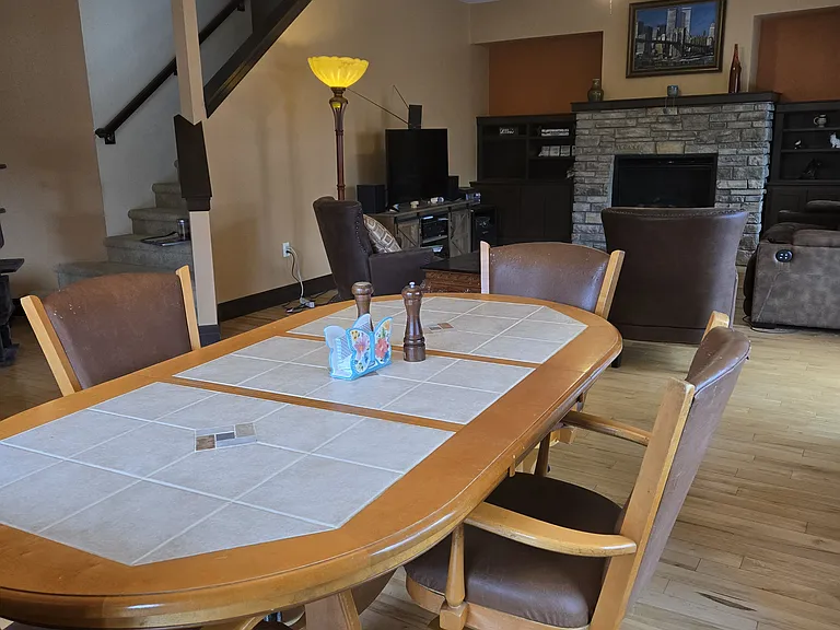 Table can be made smaller by taking middle leaf out. All floors on the main level are real hardwood.