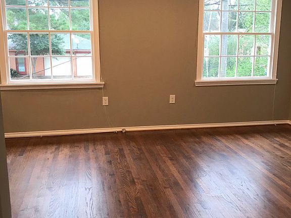 Living room with abundant lighting and original hardwood