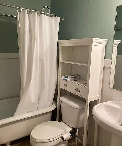 Bathroom with clawfoot tub and pedestal sink