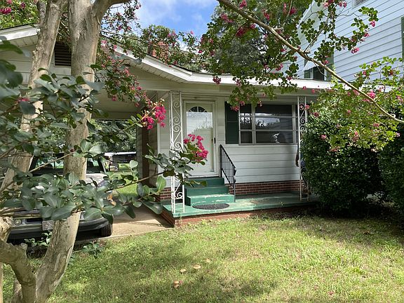 Attached carport and covered walk to side door.