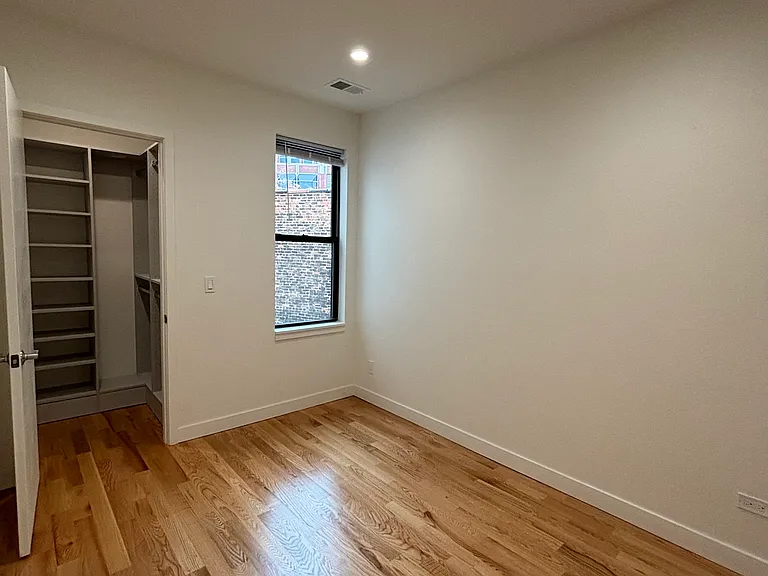 Other angle of primary bedroom with walk-in closet