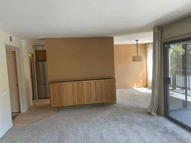 Living room and dining room / built-in storage. - 3299 La Mesa Dr #5