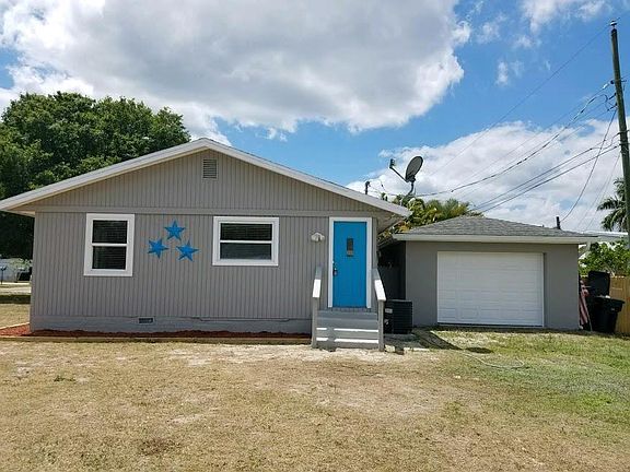 Front of home with garage both now have newer metal roofs.