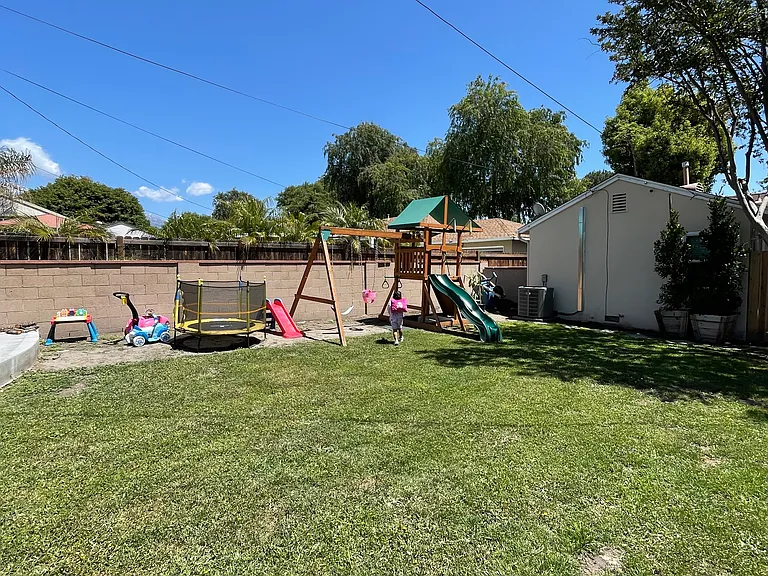 Large shared backyard with green space and room to relax outdoors.