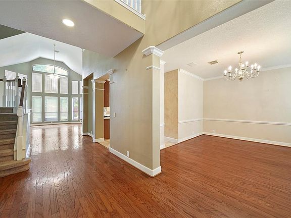 Large formal dinning room leading into the main stair case and attached to living room and leading to the family room