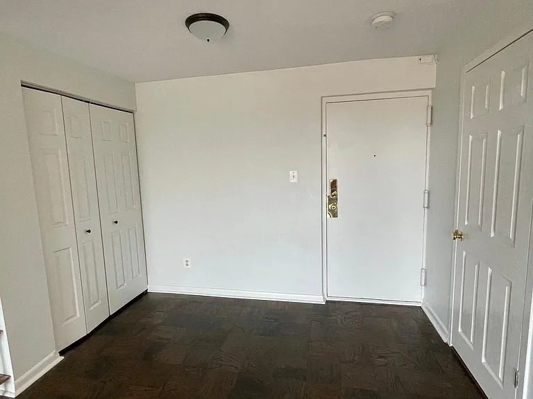 Front door. Doors on the left open to an entry way closet. Door on the right opens to a storage unit.
