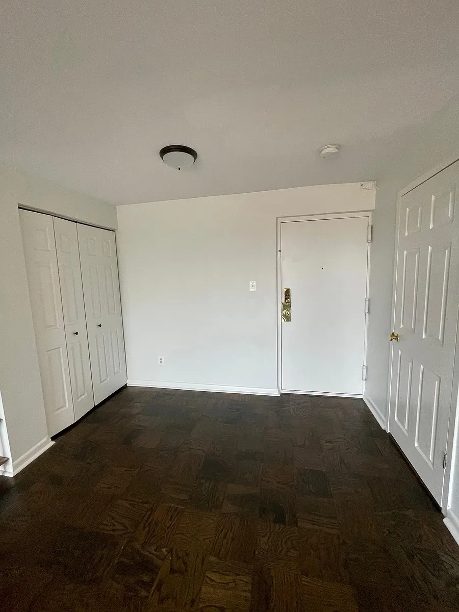 Front door. Doors on the left open to an entry way closet. Door on the right opens to a storage unit. - 1510 12th St N #304