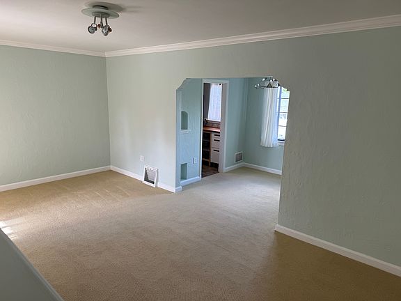 View of living room, dining room, and kitchen.