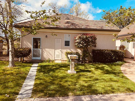 1 Greeting you home, a green, sunny and blue-skied entrance. To the left is your dedicated patio area. BBQ anyone?