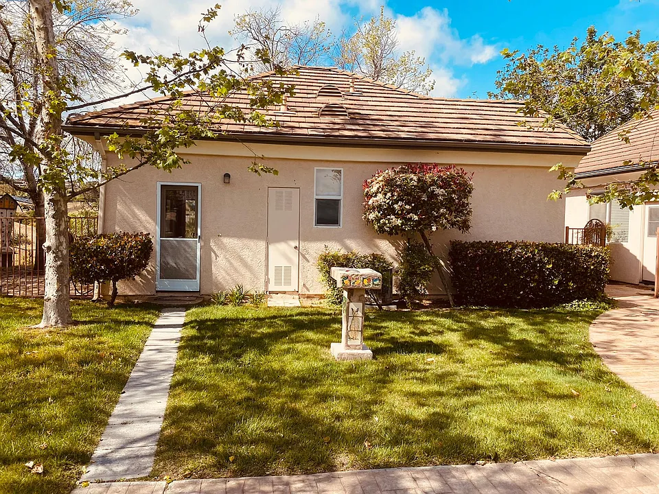 1 Greeting you home, a green, sunny and blue-skied entrance. To the left is your dedicated patio area. BBQ anyone?