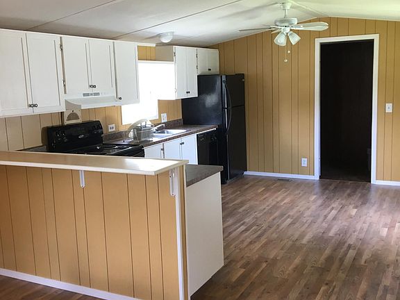 Newly remodeled kitchen includes refrigerator.