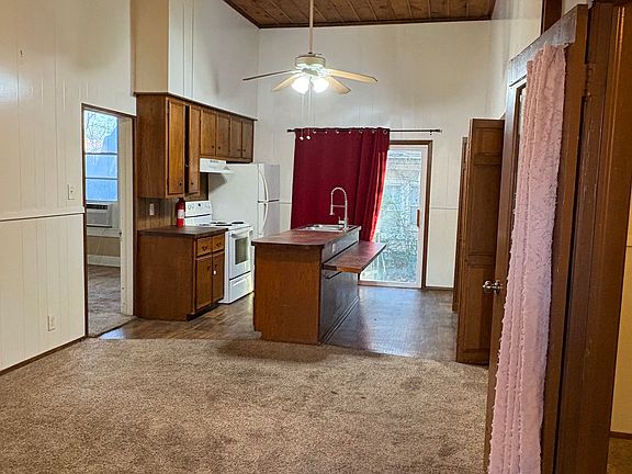 Enter into the living area which opens to the kitchen and island with fold down dining bar.